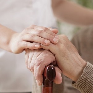 Nurse assisting ill elder man